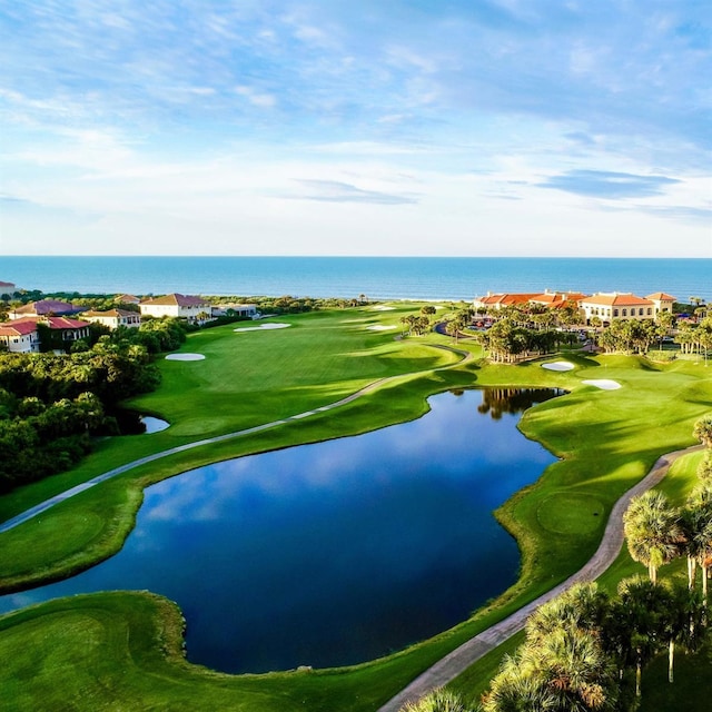 aerial view with a water view and view of golf course