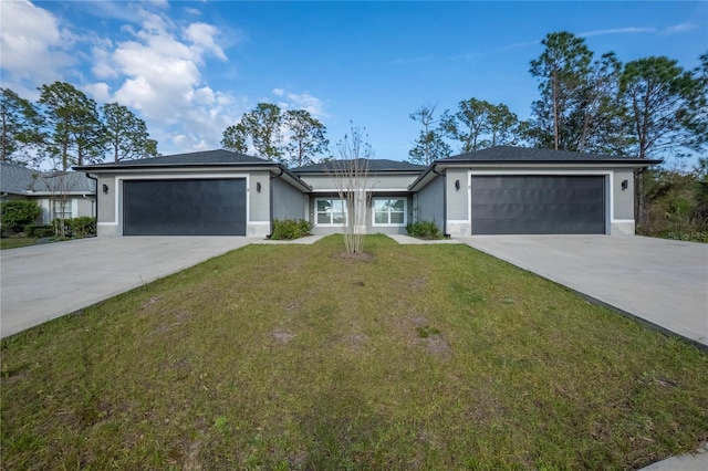 view of front of property with a garage, concrete driveway, a front lawn, and stucco siding