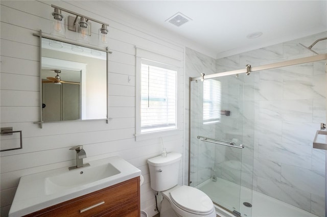 full bathroom with a stall shower, visible vents, vanity, and toilet