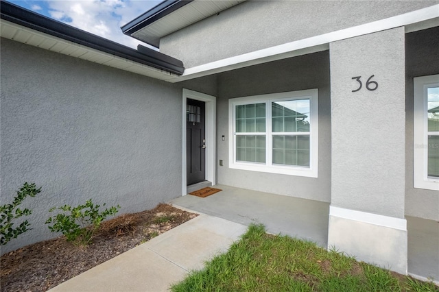 doorway to property with stucco siding