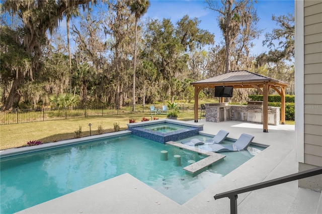 view of pool with fence, a yard, a gazebo, exterior kitchen, and a patio area