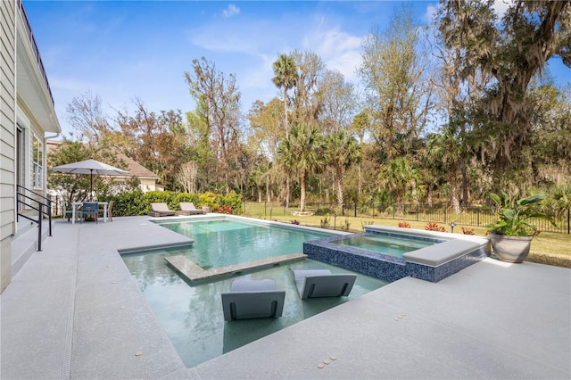 view of pool featuring a patio area, a fenced backyard, and a pool with connected hot tub