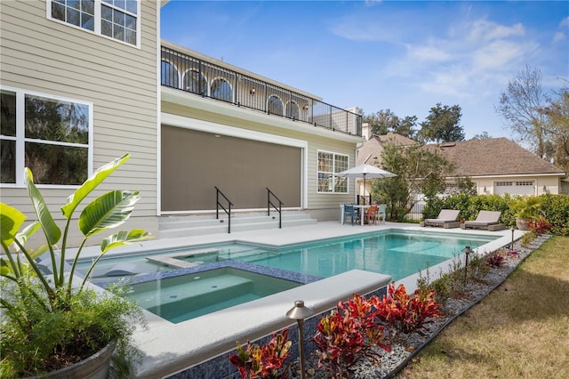 view of pool featuring entry steps, a patio area, and a pool with connected hot tub