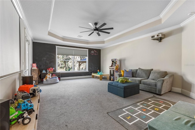 living room with crown molding, a ceiling fan, a raised ceiling, and carpet flooring