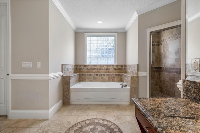 full bath with a textured ceiling, ornamental molding, a tile shower, and a bath