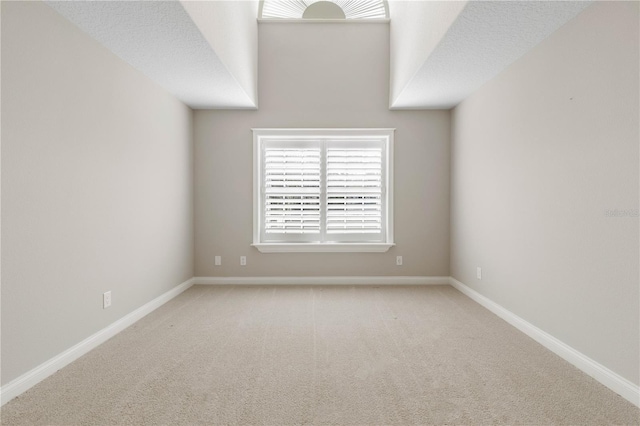 unfurnished room featuring carpet and baseboards