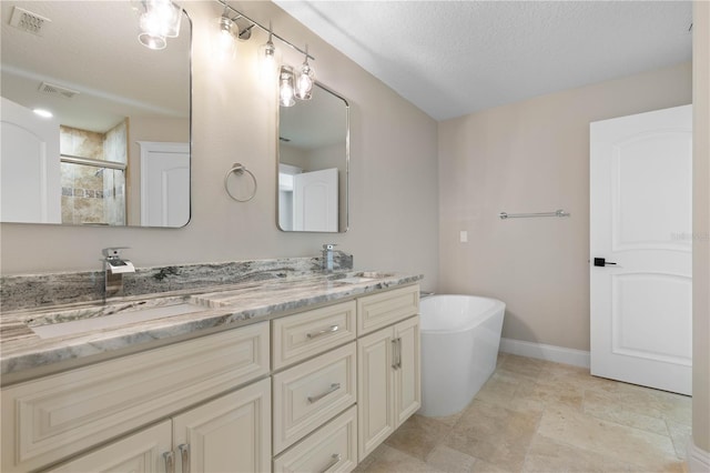 bathroom with a sink, visible vents, and a shower stall