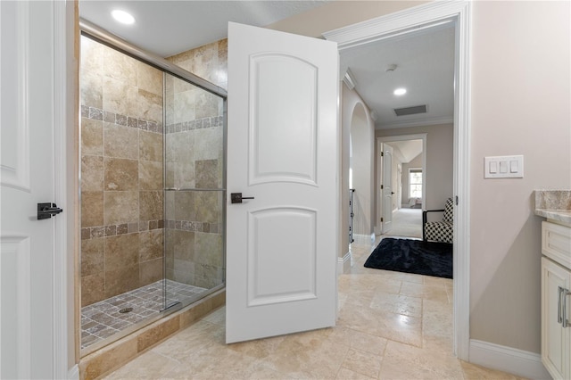 ensuite bathroom with ensuite bath, a shower stall, baseboards, and vanity