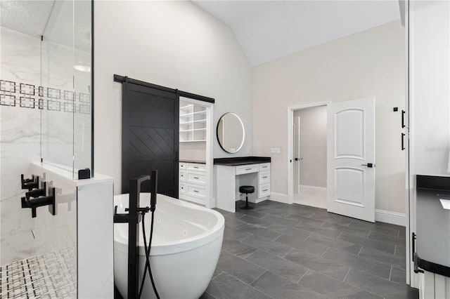 full bathroom featuring lofted ceiling, a soaking tub, a shower stall, and baseboards