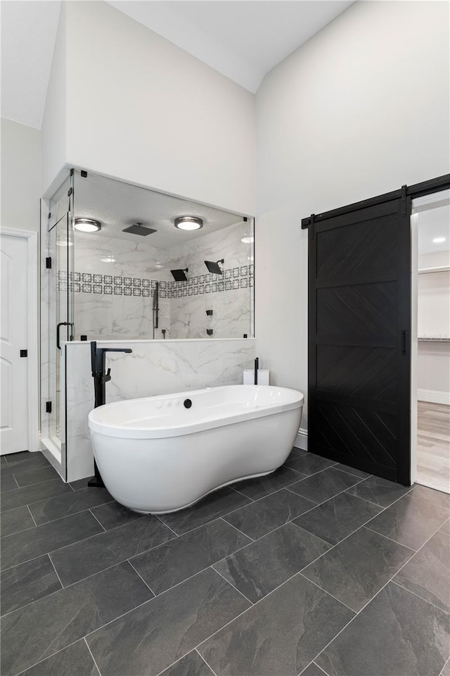 full bath with vaulted ceiling, a soaking tub, and a shower stall