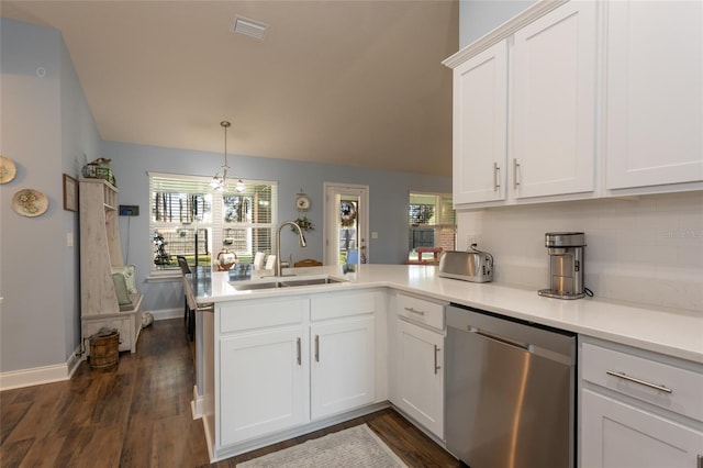 kitchen featuring visible vents, white cabinets, a sink, dishwasher, and a peninsula