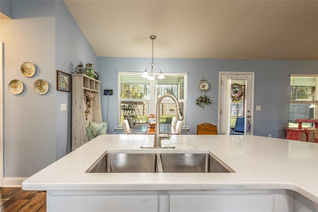 kitchen featuring a chandelier, dark wood finished floors, a sink, and a wealth of natural light