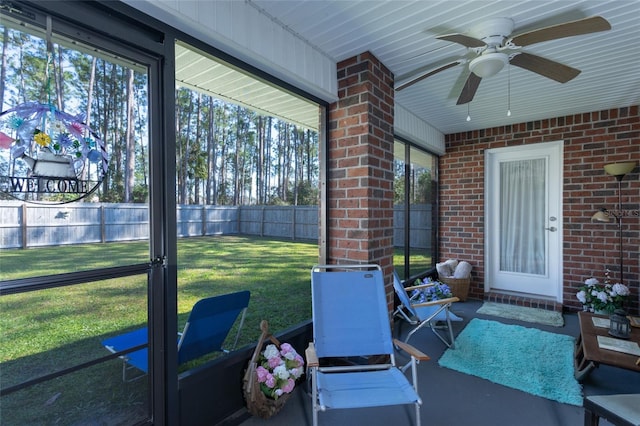 sunroom featuring ceiling fan