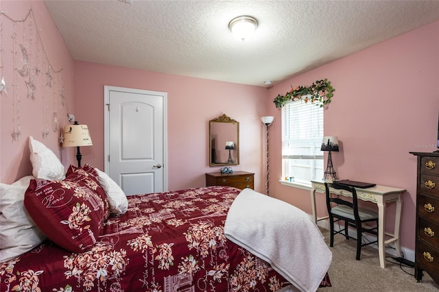 carpeted bedroom featuring a textured ceiling