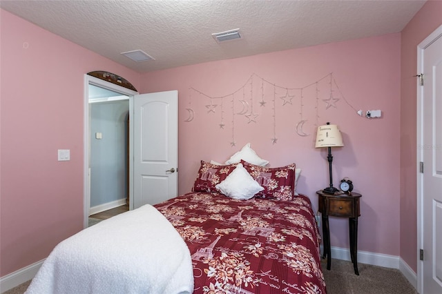 carpeted bedroom with a textured ceiling, visible vents, and baseboards