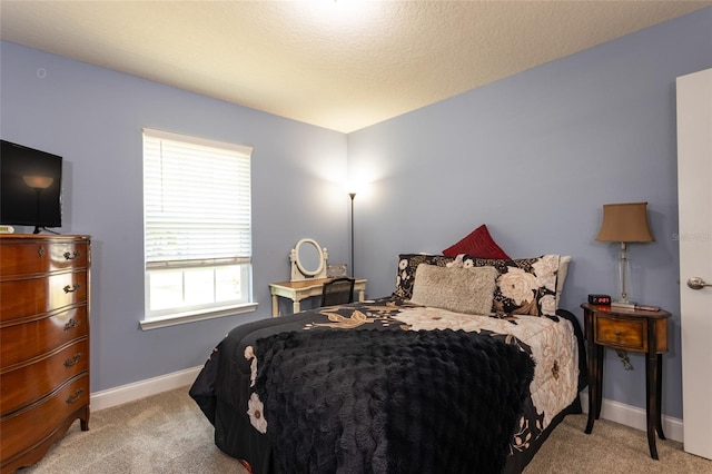 carpeted bedroom with a textured ceiling and baseboards