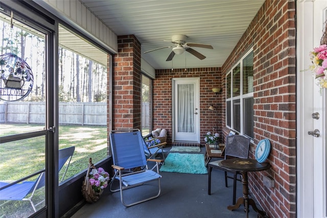 sunroom / solarium featuring a ceiling fan