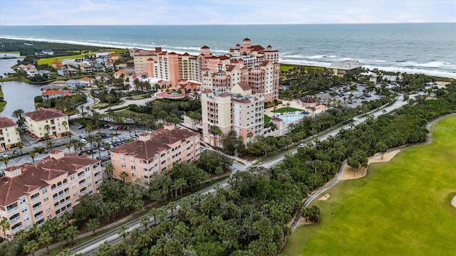 drone / aerial view featuring a view of the beach, a view of city, and a water view