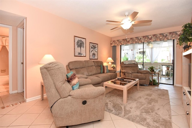 living area featuring a ceiling fan, baseboards, and light tile patterned floors