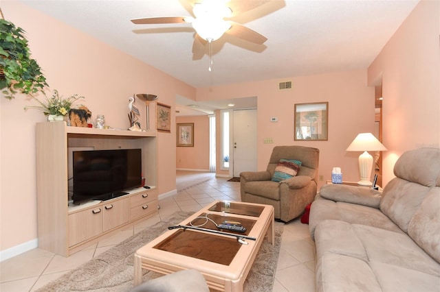 living area featuring light tile patterned floors, baseboards, visible vents, and ceiling fan