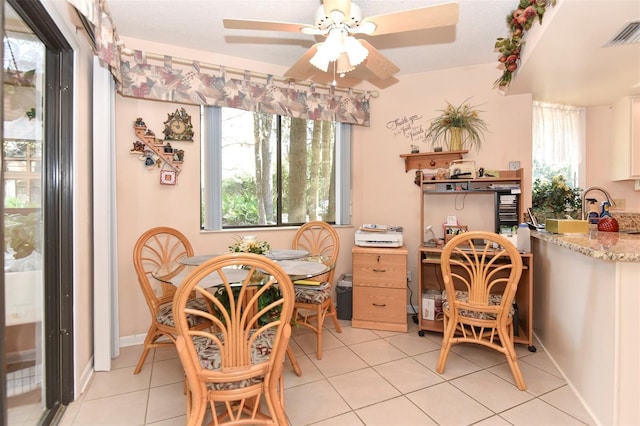 dining space featuring light tile patterned floors, ceiling fan, and visible vents