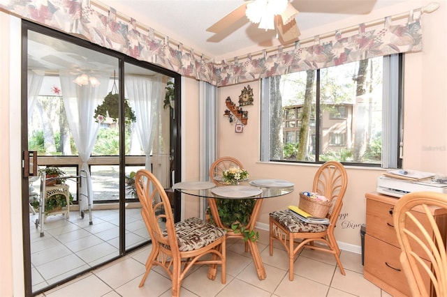 dining room featuring light tile patterned floors, baseboards, and a ceiling fan