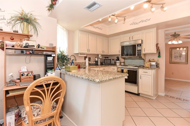 kitchen featuring electric stove, stainless steel microwave, visible vents, and light tile patterned flooring