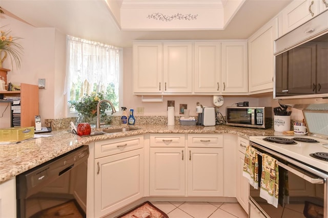 kitchen with a sink, white cabinetry, electric stove, dishwasher, and stainless steel microwave