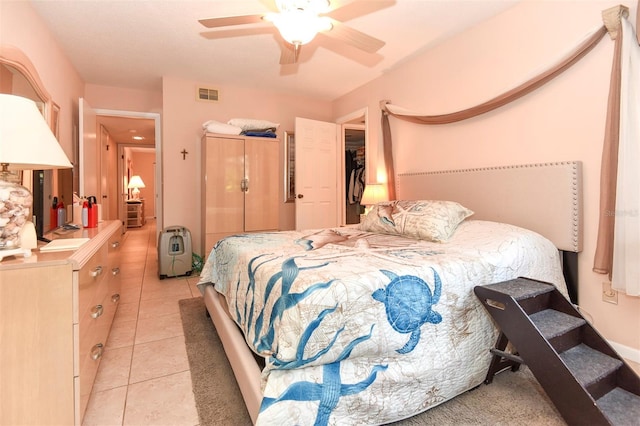 bedroom featuring light tile patterned floors, visible vents, and a ceiling fan