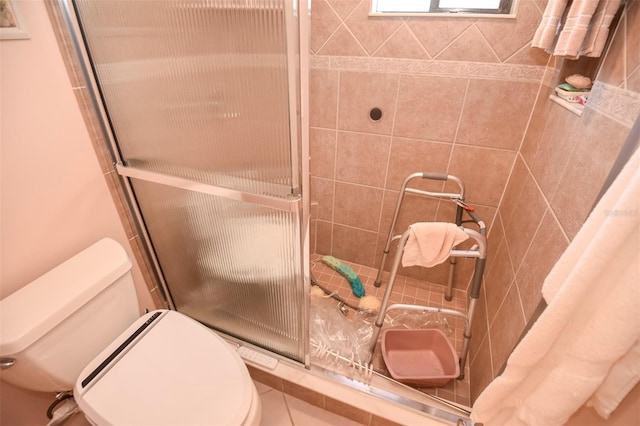 bathroom featuring a shower stall and toilet