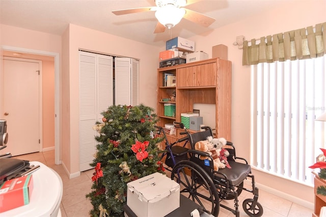 office area with light tile patterned floors, plenty of natural light, baseboards, and a ceiling fan