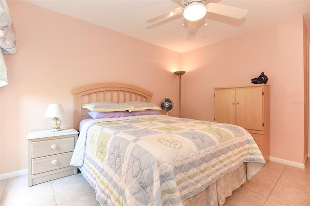 bedroom featuring ceiling fan, baseboards, and light tile patterned floors