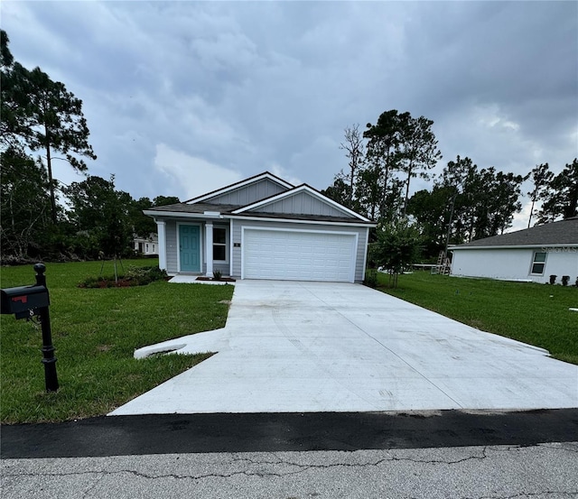 ranch-style house with board and batten siding, a front yard, driveway, and a garage