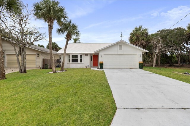 ranch-style home with brick siding, concrete driveway, metal roof, a garage, and a front lawn