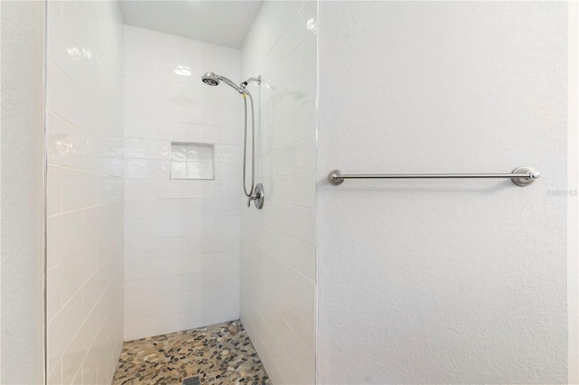 bathroom with a tile shower