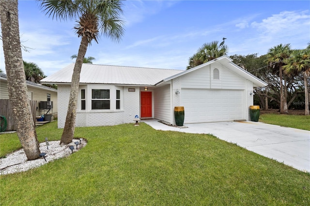 ranch-style house featuring metal roof, a garage, brick siding, concrete driveway, and a front lawn