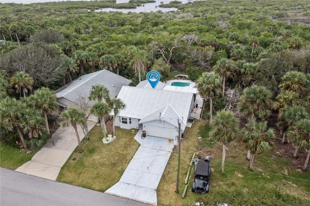 drone / aerial view featuring a wooded view