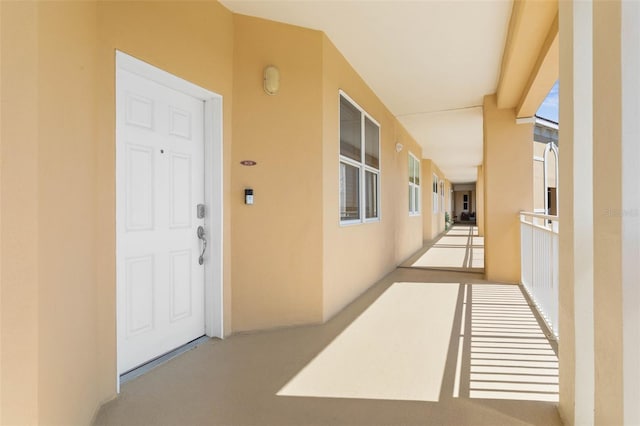 entrance to property featuring stucco siding