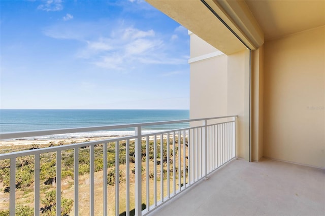 balcony featuring a water view and a view of the beach