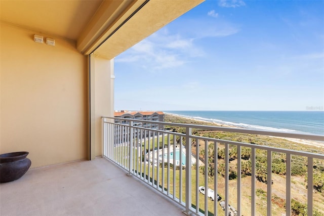 balcony featuring a water view and a beach view