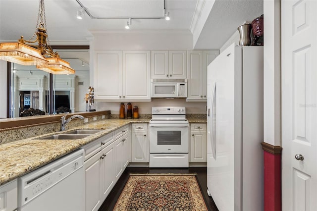 kitchen featuring white appliances, white cabinetry, ornamental molding, and a sink