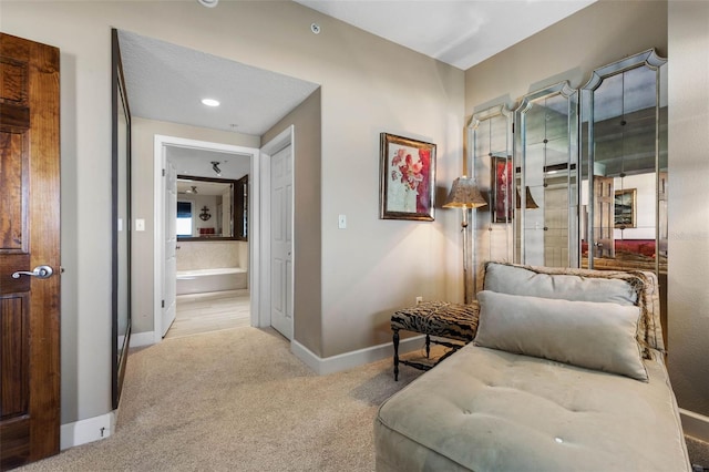 corridor with carpet floors and baseboards