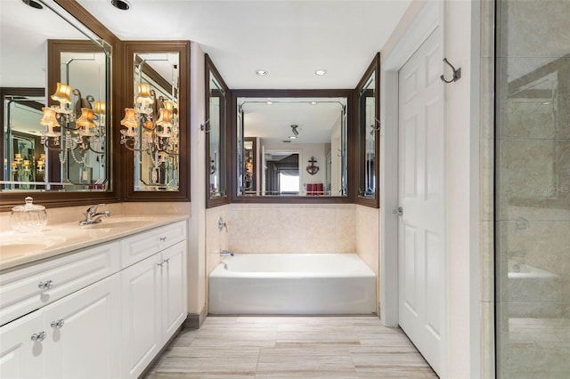 full bathroom featuring a garden tub, double vanity, and a sink