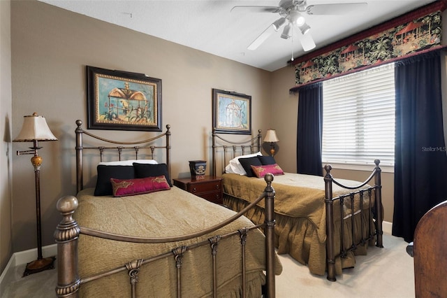 bedroom featuring a ceiling fan, light colored carpet, and baseboards