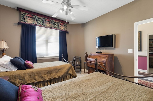 bedroom with baseboards and a ceiling fan