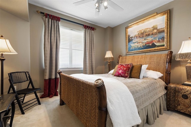 bedroom featuring a ceiling fan and light colored carpet