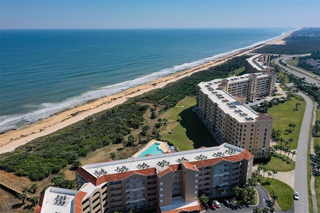 drone / aerial view featuring a beach view and a water view