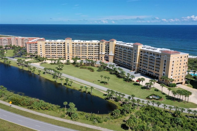 birds eye view of property featuring a water view and a city view