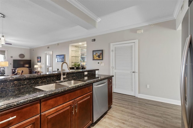 kitchen with ornamental molding, visible vents, a sink, and stainless steel dishwasher