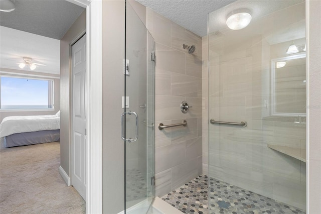 bathroom featuring a textured ceiling, a shower stall, and ensuite bathroom